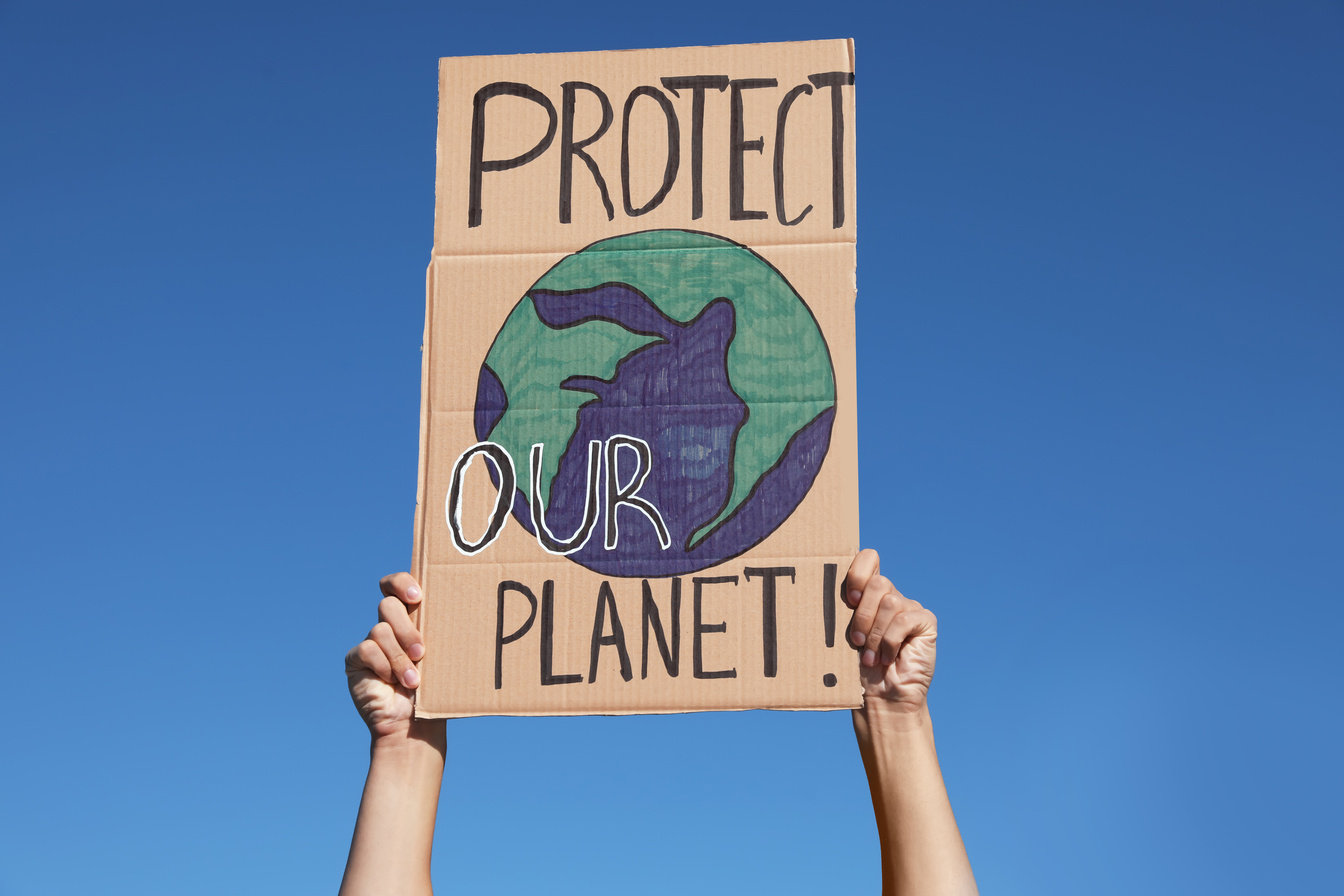 Man with Poster Protesting against Climate Change Outdoors, Clos