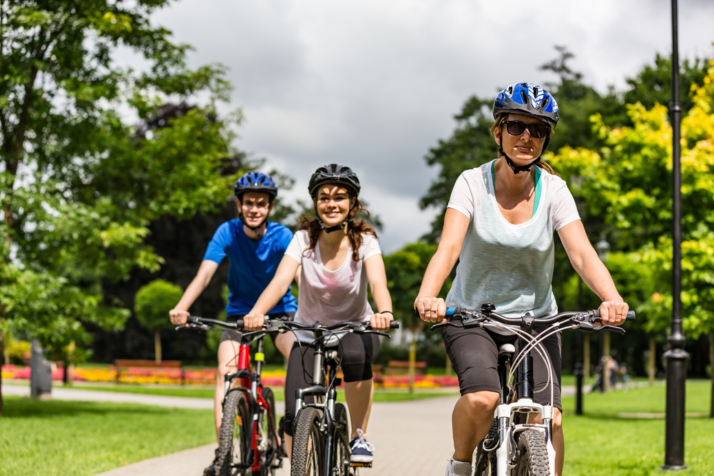 Urban biking- three people riding bikes in city